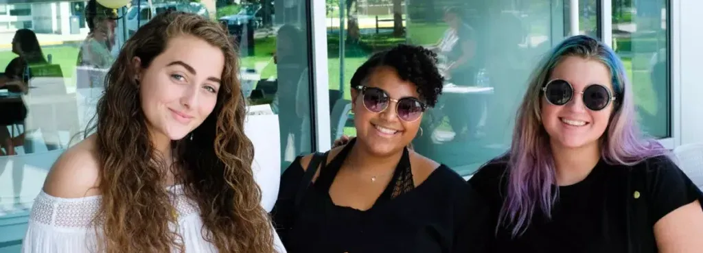 three students smiling